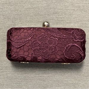 Purple clutch with embroidery.